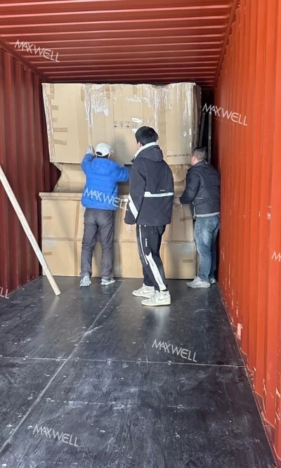 The workers of Maxwell are working hard to load the goods The workers of Maxwell are working hard to load the goods