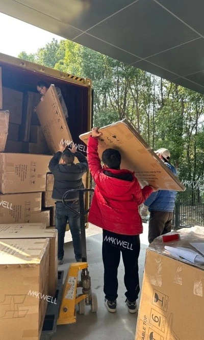 The workers of Maxwell are working hard to load the goods The workers of Maxwell are working hard to load the goods